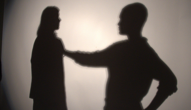 Schaduwen van twee mensen op een witte muur