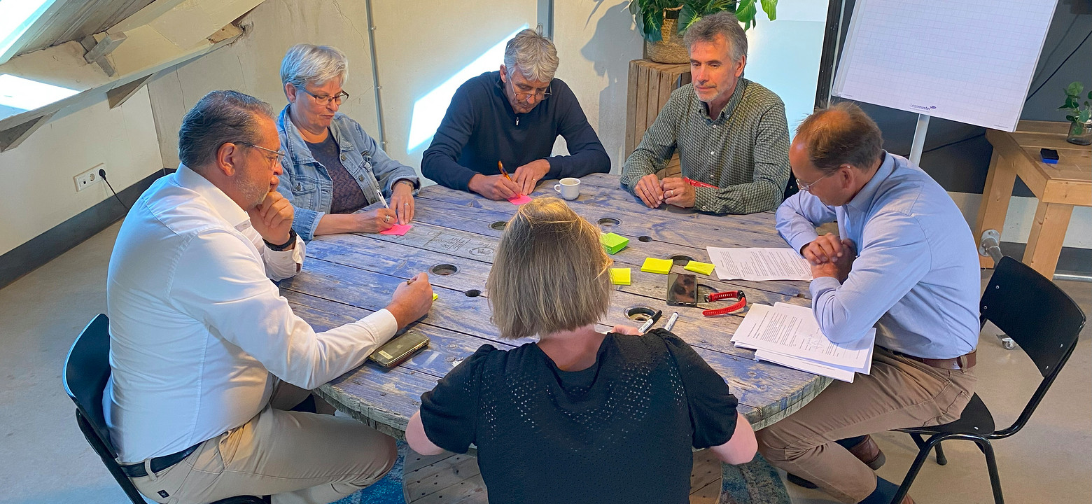 Deelnemers brainstormen rond een tafel