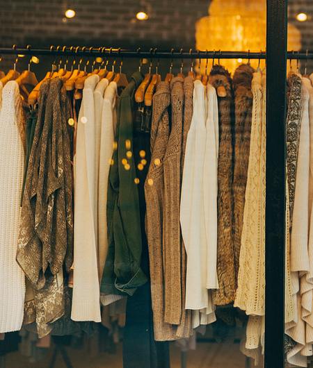 Clothes on clothing rack behind shop window