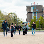 Group of students walking with Van OlstBorg in background