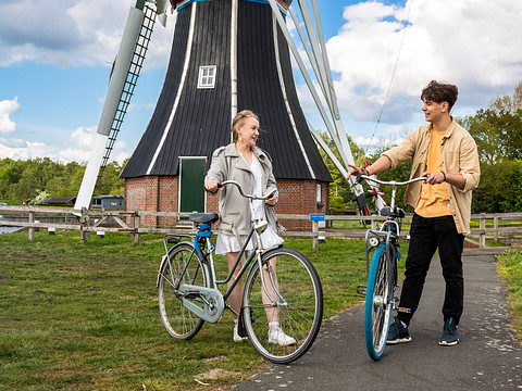 students with bikes at mill