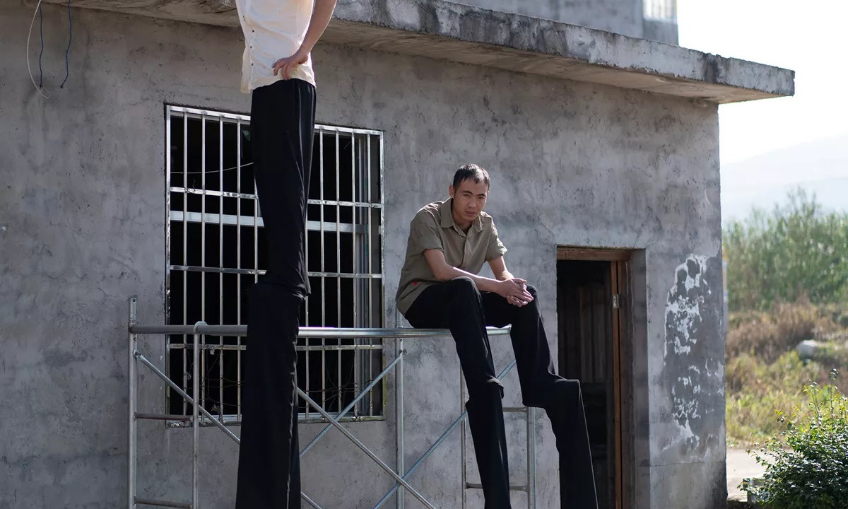 man on stilts with sitting man on stilts.jpg