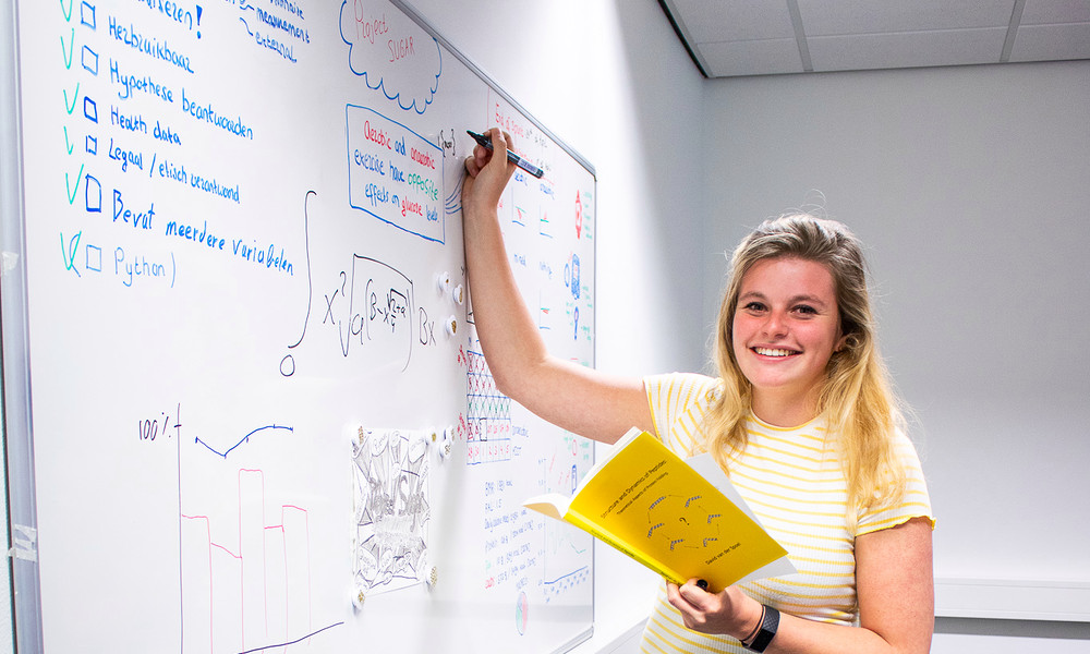 Student Master Data Science for Life Sciences writes on board