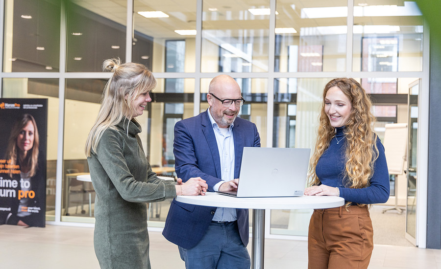 Medewerkers overleggen bij laptop 2023 klein.jpg