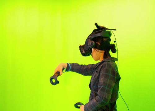 person doing virtual reality in a green room