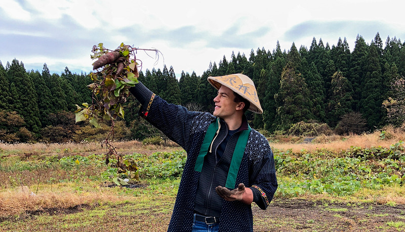 Student in Japan holding crop, dressed in Japanese clothing