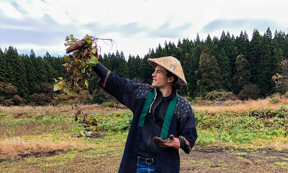 Student in Japan holding crop, dressed in Japanese clothing
