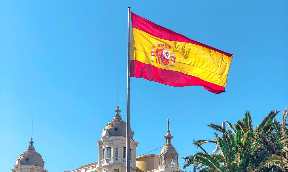 Spanish flag with building behind it