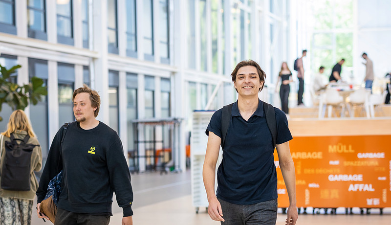 IBS students Pim and Thyme walking towards camera in Atrium on Zernike campus